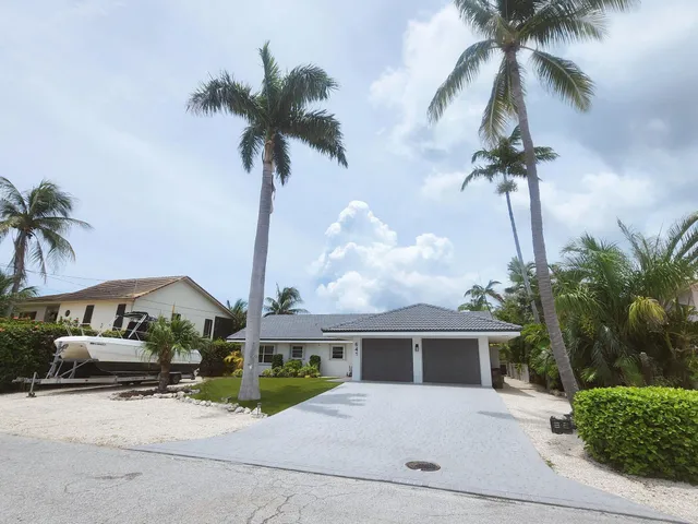 a view of a patio with table and chairs potted plants