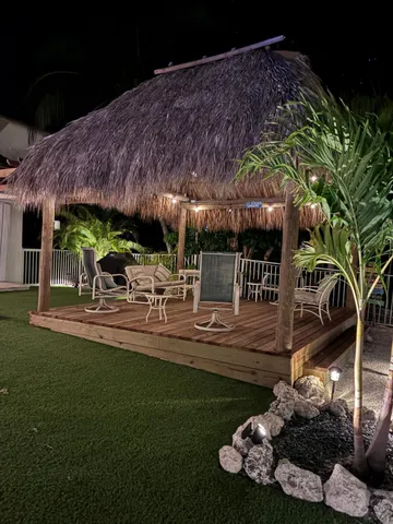 a view of a patio with table and chairs with wooden floor