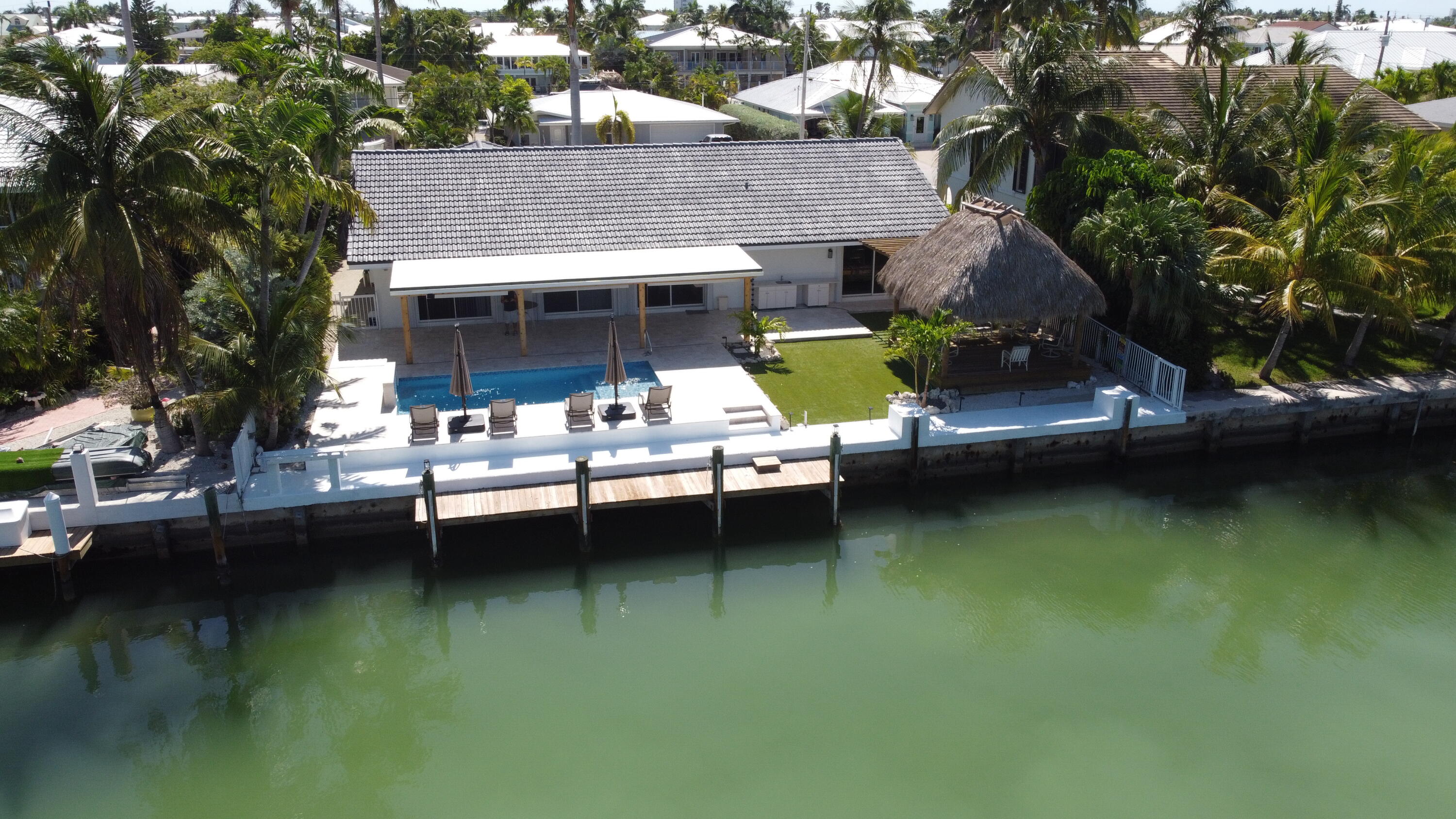 641 12th Street Key Colony Beach, FL 33051 - Photo 39 of 49 a view of house with swimming pool and outdoor seating