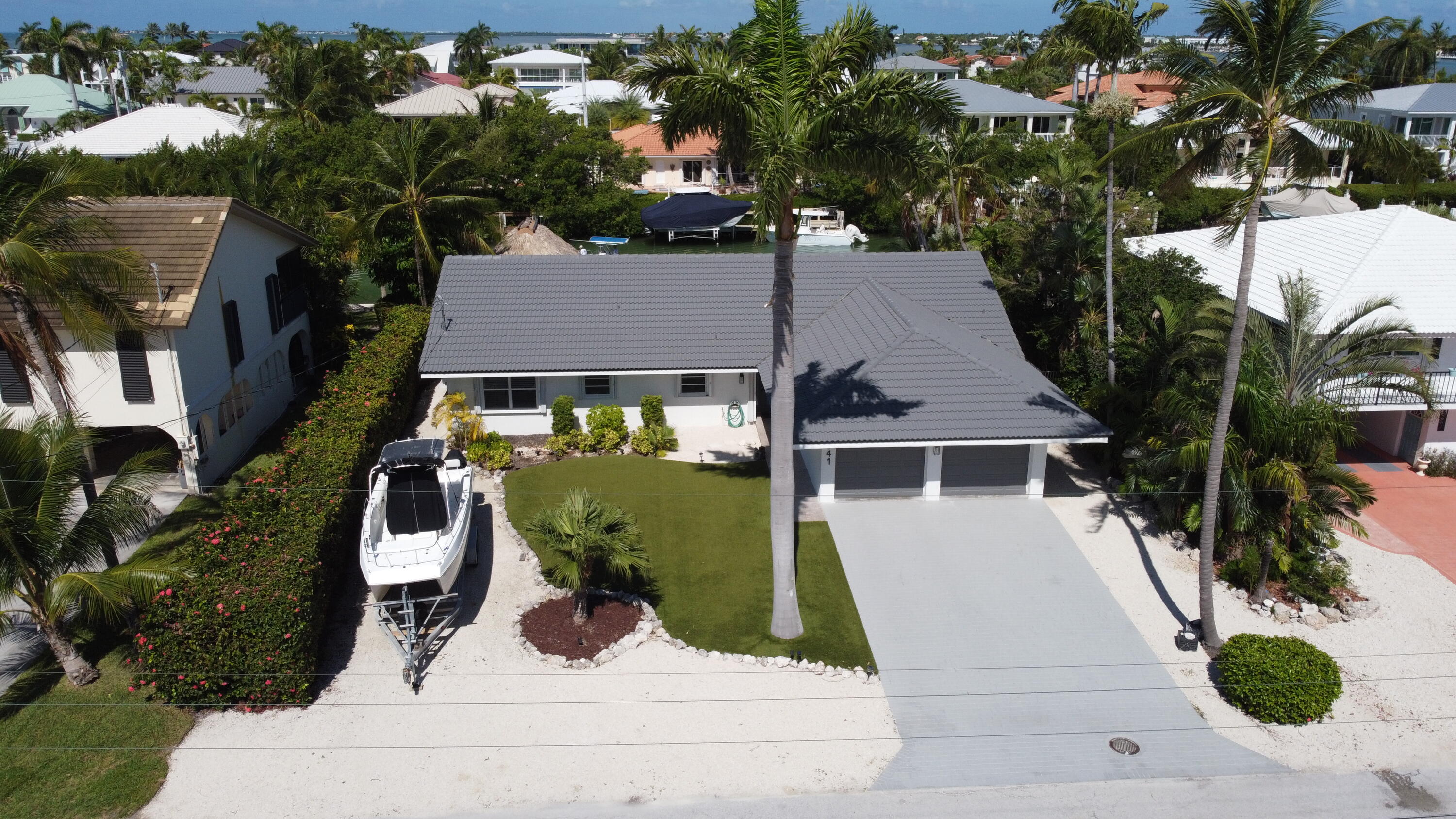 641 12th Street Key Colony Beach, FL 33051 - Photo 4 of 45 an aerial view of a house with a yard and potted plants