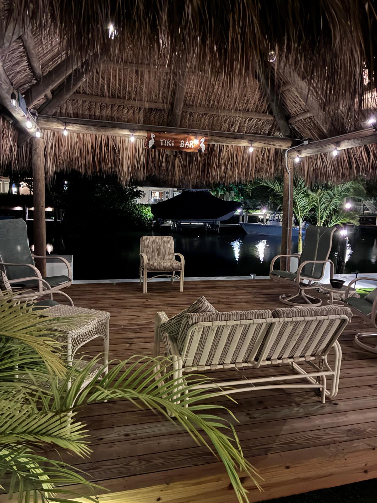 641 12th Street Key Colony Beach, FL 33051 - Photo 43 of 49 a view of a patio with table and chairs with wooden floor
