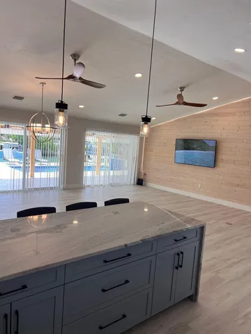 a bathroom with a granite countertop sink a large mirror and vanity