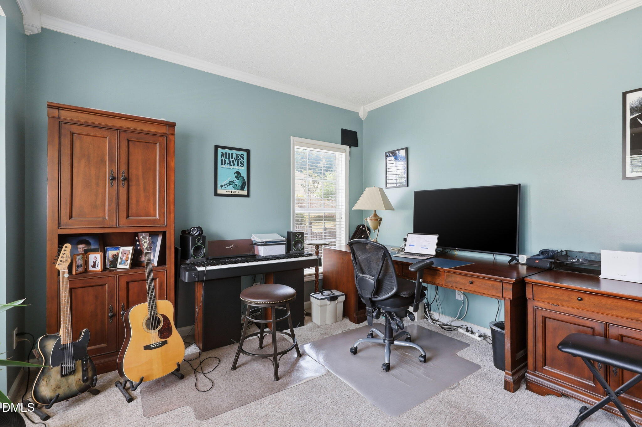 9105 Willow Valley Court Raleigh, NC 27617 - Photo 3 of 51 a view of a workspace with furniture and a window