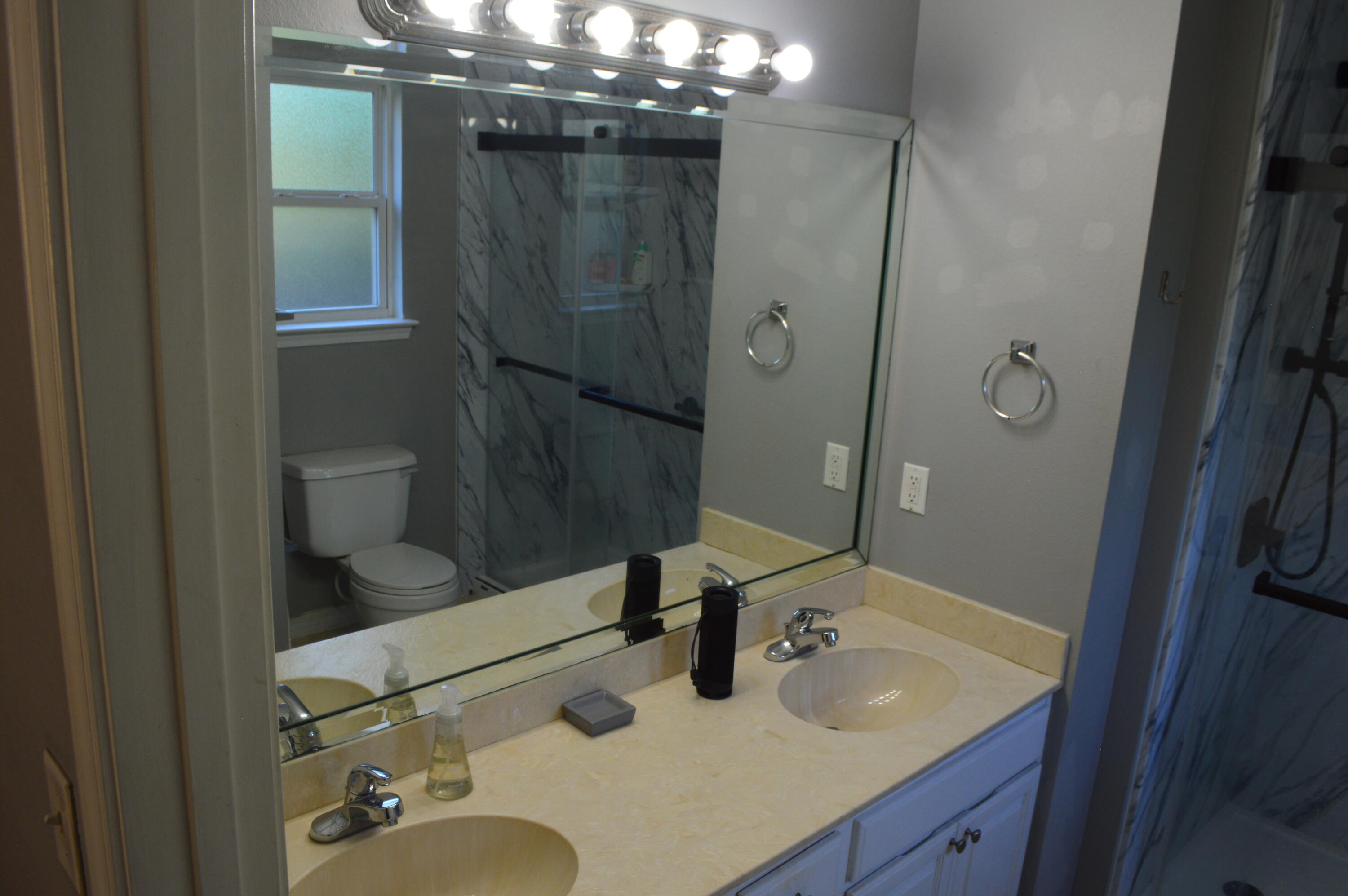 1705 North Pearl Street Crestview, FL 32536 - Photo 3 of 6 a bathroom with a sink double vanity and mirror
