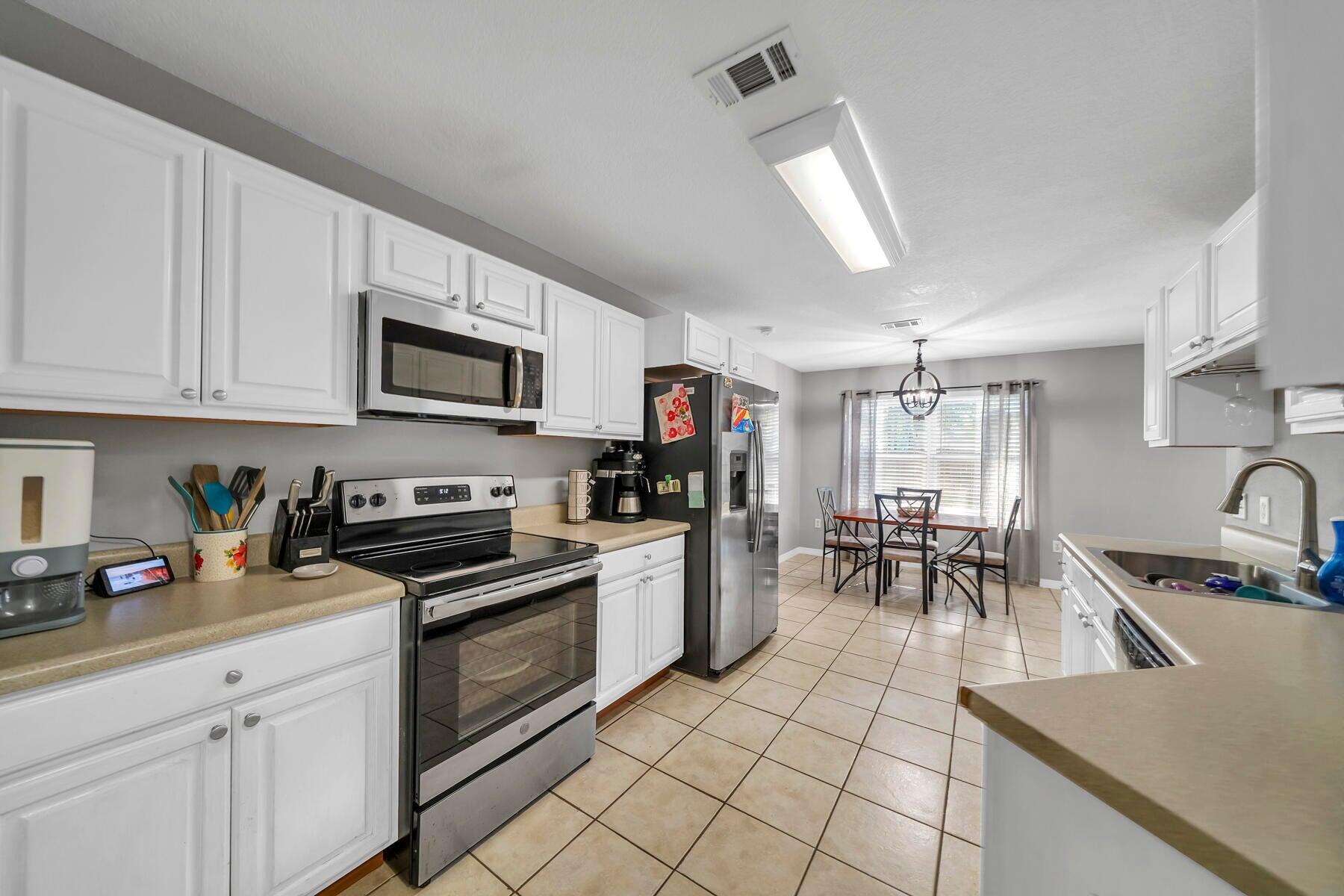 1705 North Pearl Street Crestview, FL 32536 - Photo 6 of 6 a kitchen with a sink a stove and cabinets