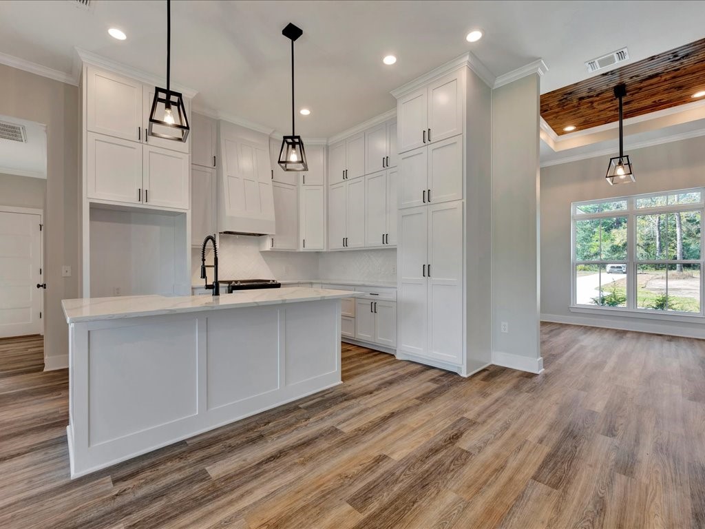 529 C C Road Diboll, TX 75941 - Photo 11 of 35 a kitchen with kitchen island white cabinets and wooden floor