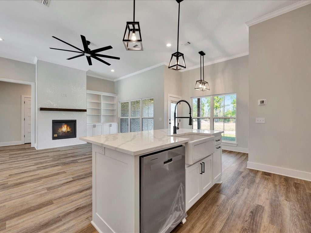 529 C C Road Diboll, TX 75941 - Photo 13 of 35 a view of a kitchen with a sink wooden floor and a window