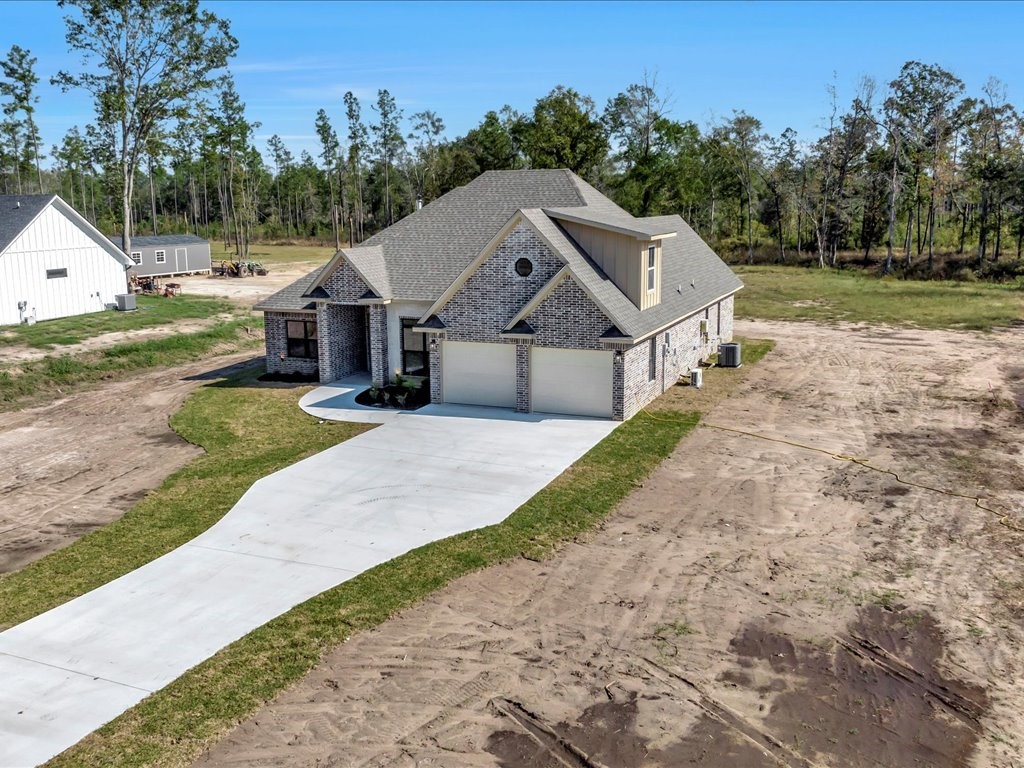 529 C C Road Diboll, TX 75941 - Photo 29 of 35 a front view of a house with a yard and garage
