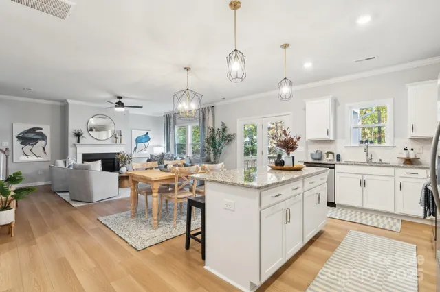 a large kitchen with lots of counter space and living room view