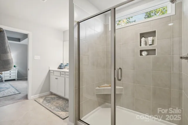 a bathroom with a shower and a sink
