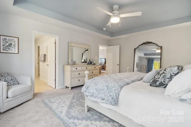 a spacious bedroom with a bed a couch and dresser