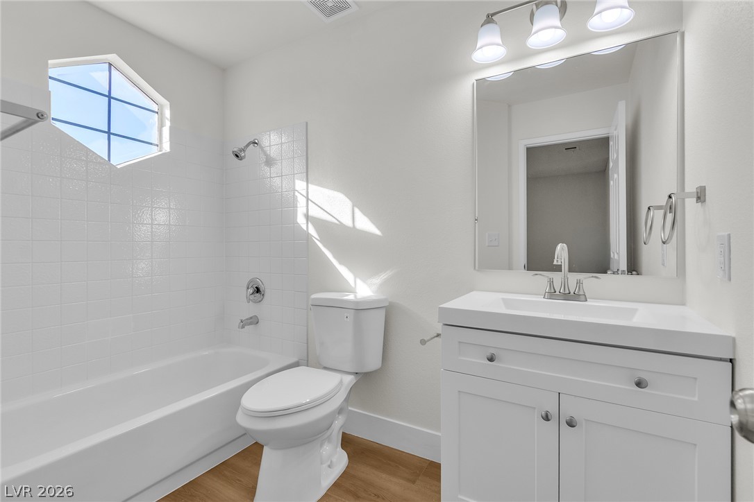 370 Rushing Creek Court Henderson, NV 89014 - Photo 28 of 32 Sunlight streams through a geometric window into a freshly updated bathroom with modern finishes.