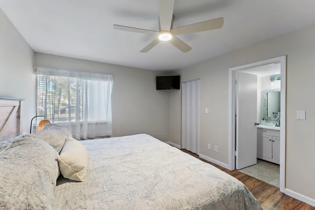 a bedroom with a large bed and a chandelier