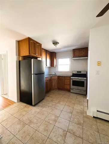 a kitchen with granite countertop a refrigerator and a stove top oven
