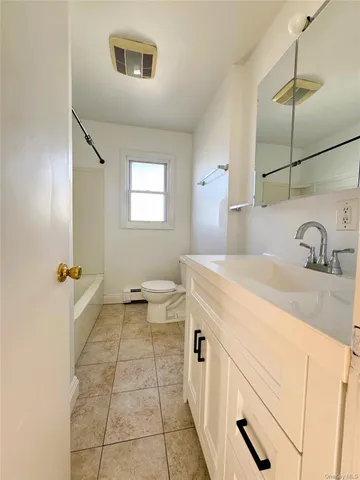 a spacious bathroom with a sink and a mirror