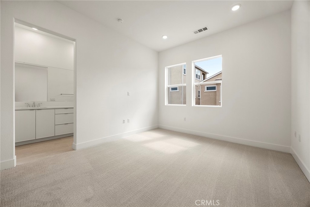 124 Tiffin Irvine, CA 92618 - Photo 15 of 26 an empty room with windows and cabinet