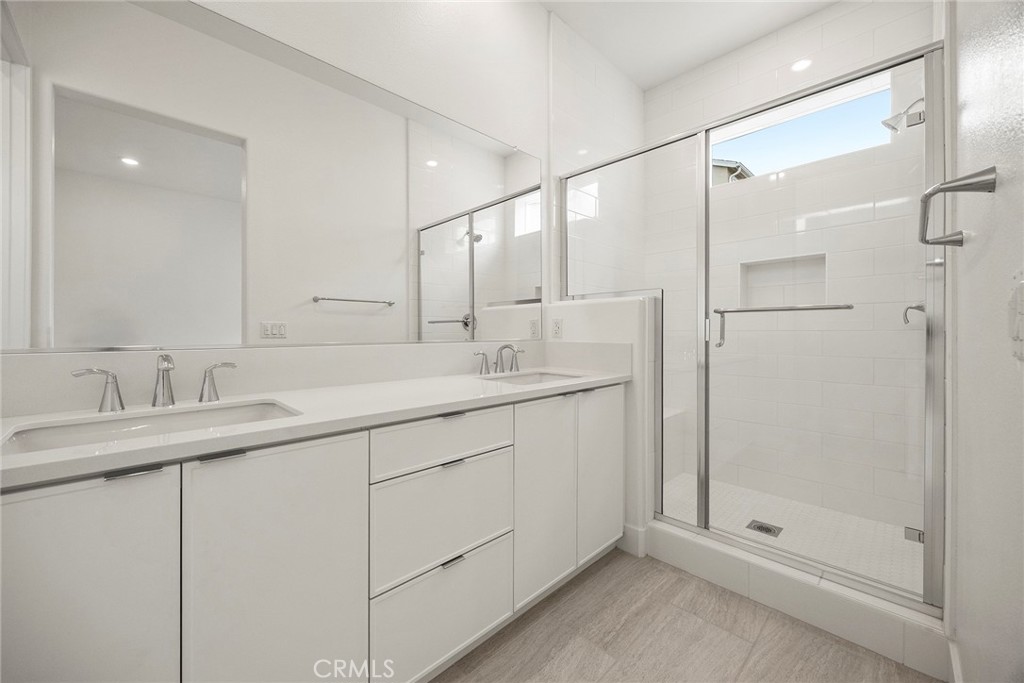 124 Tiffin Irvine, CA 92618 - Photo 16 of 26 a bathroom with a shower sink and mirror