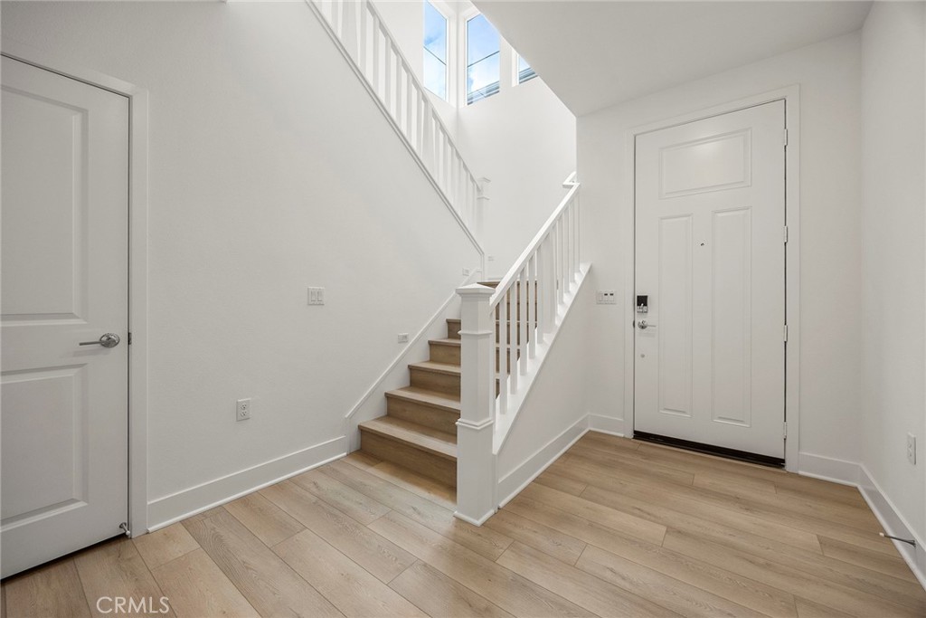 124 Tiffin Irvine, CA 92618 - Photo 2 of 26 a view of a hallway with wooden floor and entryway