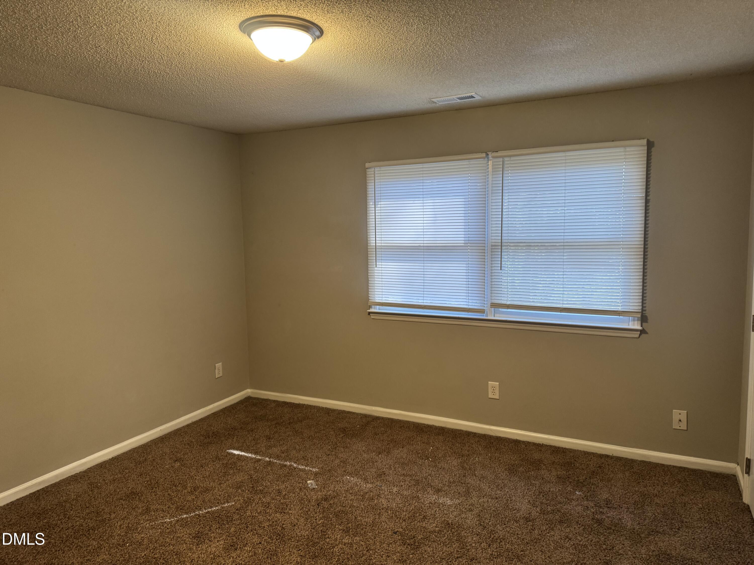 5105 Vann Street, Unit C Raleigh, NC 27606 - Photo 8 of 11 an empty room with a window