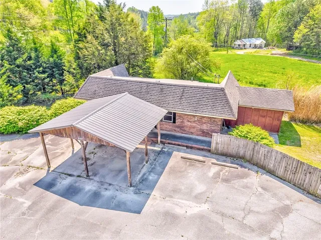a view of a patio with lawn chairs floor to ceiling window and yard
