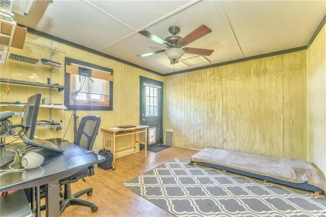 a living room with patio furniture and a chandelier