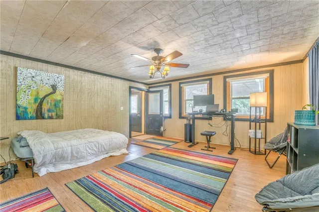 a bedroom with a bed and a chandelier