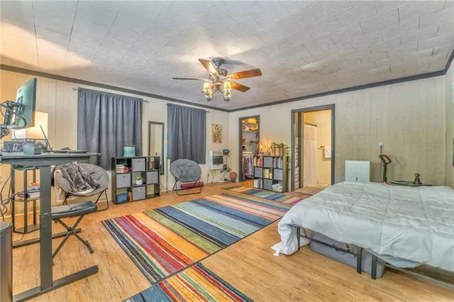 a bedroom with a bed and wooden floor