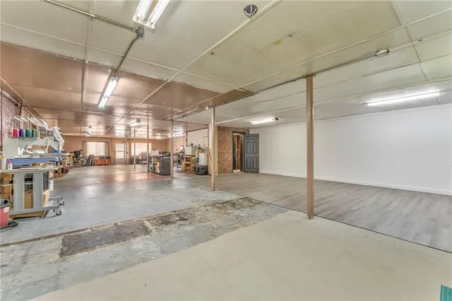 a front view of a house with a yard and potted plants