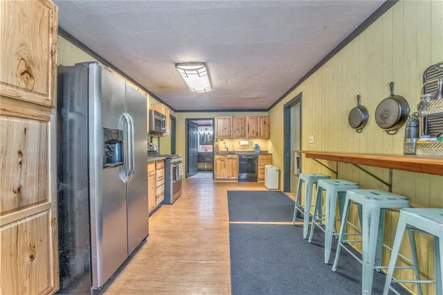 a backyard of a house with table and chairs under an umbrella