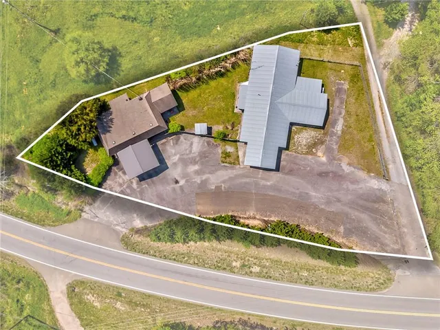 an aerial view of a residential houses with city view