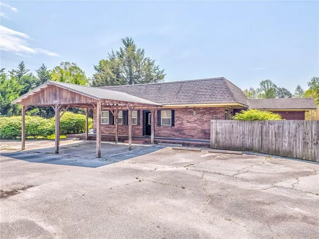 a view of a house with wooden fence