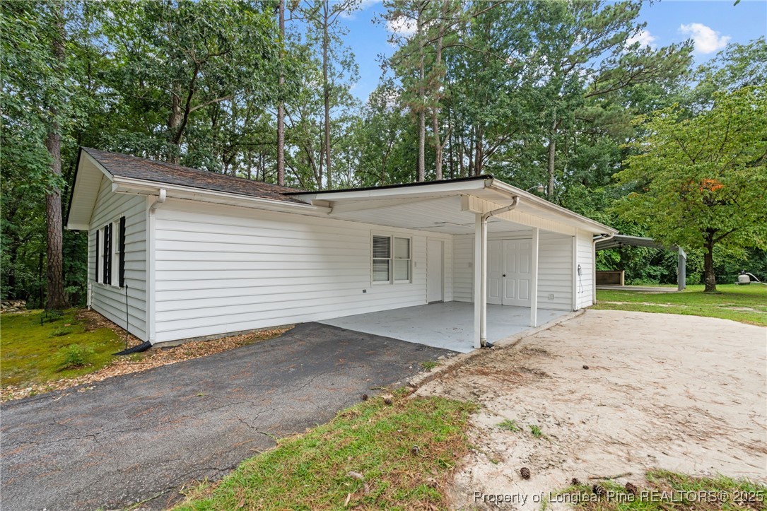610 Maynard Lake Road Erwin, NC 28339 - Photo 44 of 49 a view of a house with a yard and garage
