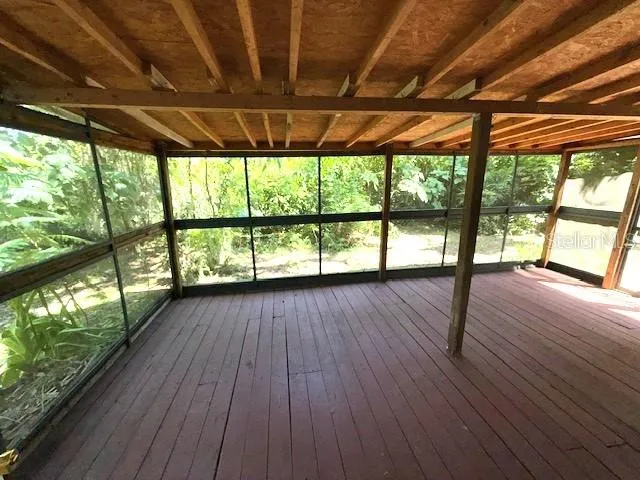 a view of room with wooden floor and outdoor space