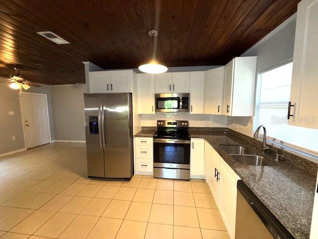 340 Mosley Road Lake Alfred, FL 33850 - Photo 3 of 13 a large kitchen with granite countertop a stove a sink dishwasher a refrigerator and a microwave oven