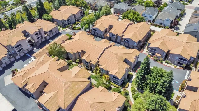 an aerial view of a house with swimming pool and outdoor seating