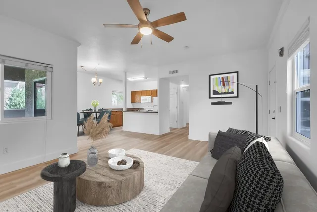 a living room with furniture and a wooden floor