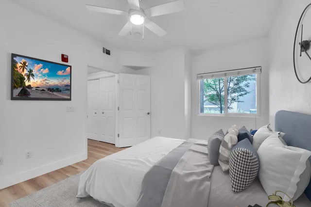 a bedroom with a bed and a painting on the wall