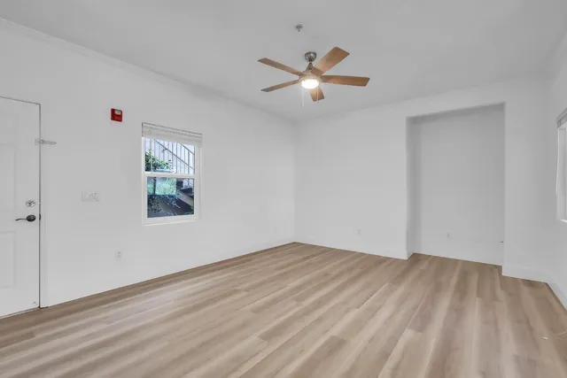 a view of empty room with wooden floor
