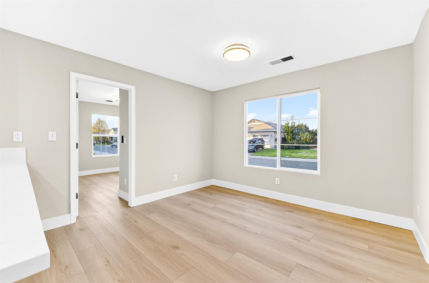 7481 Splendid Way Elk Grove, CA 95758 - Photo 15 of 41 an empty room with wooden floor and windows
