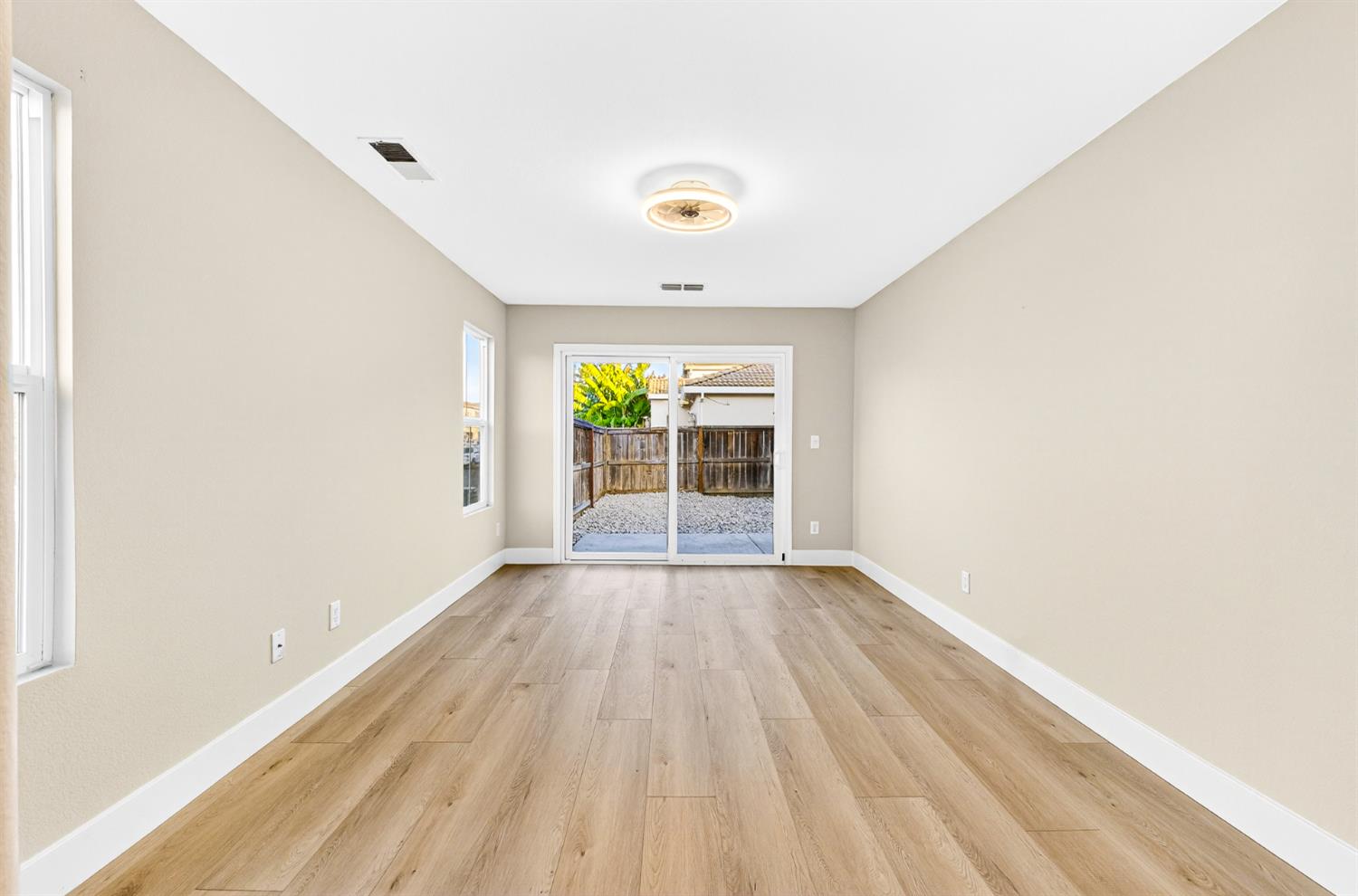 7481 Splendid Way Elk Grove, CA 95758 - Photo 21 of 41 an empty room with wooden floor and windows
