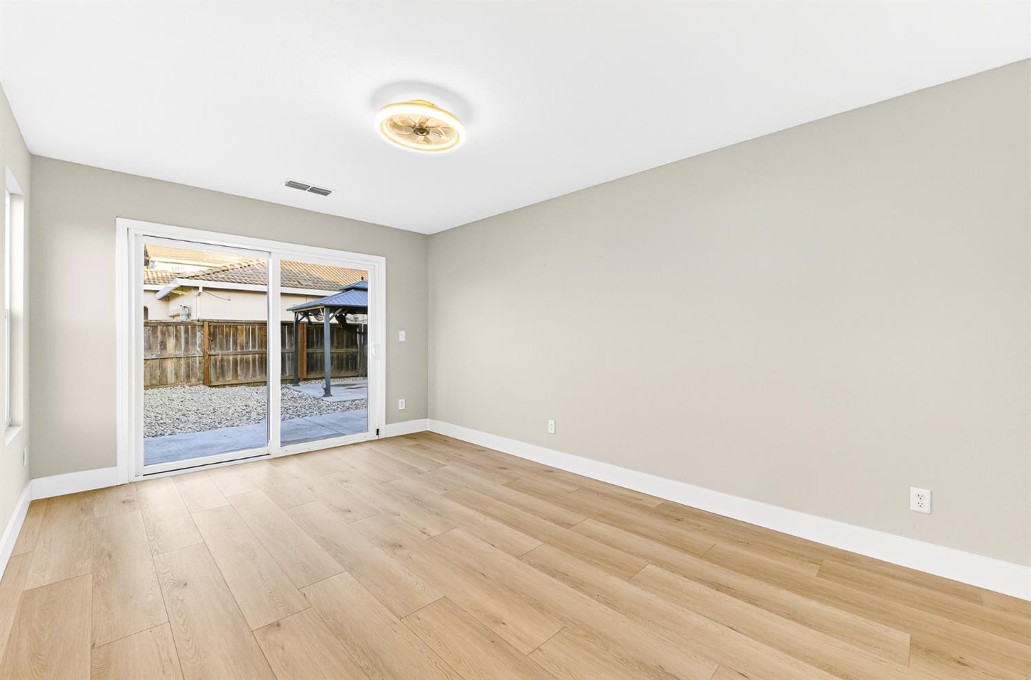 7481 Splendid Way Elk Grove, CA 95758 - Photo 22 of 41 a view of an empty room with wooden floor and a window