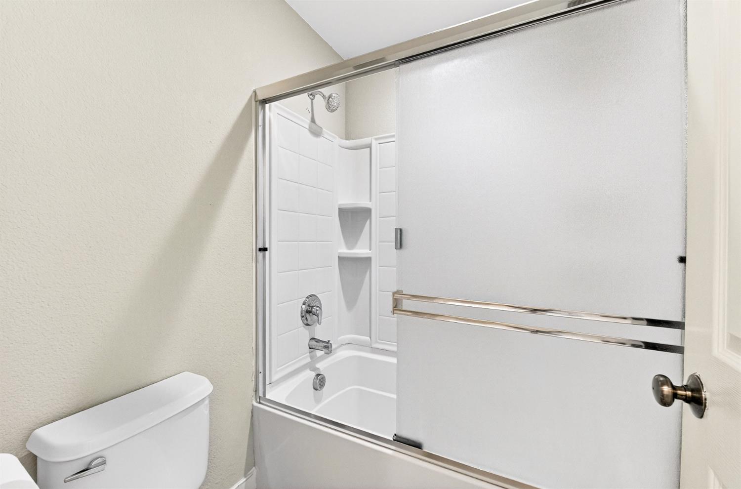 7481 Splendid Way Elk Grove, CA 95758 - Photo 24 of 41 a white toilet sitting next to a bath tub