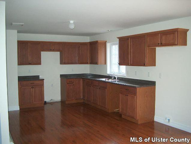 4301 Atwood Road Stone Ridge, NY 12484 - Photo 3 of 3 a kitchen with granite countertop wooden cabinets a sink and dishwasher