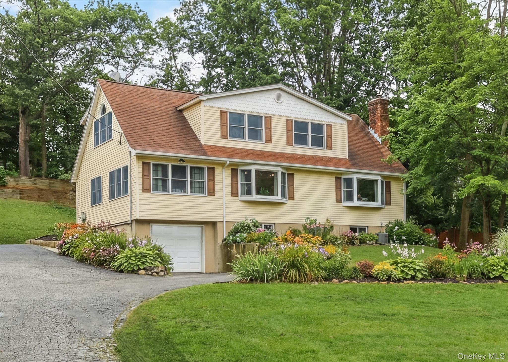 a front view of a house with a garden