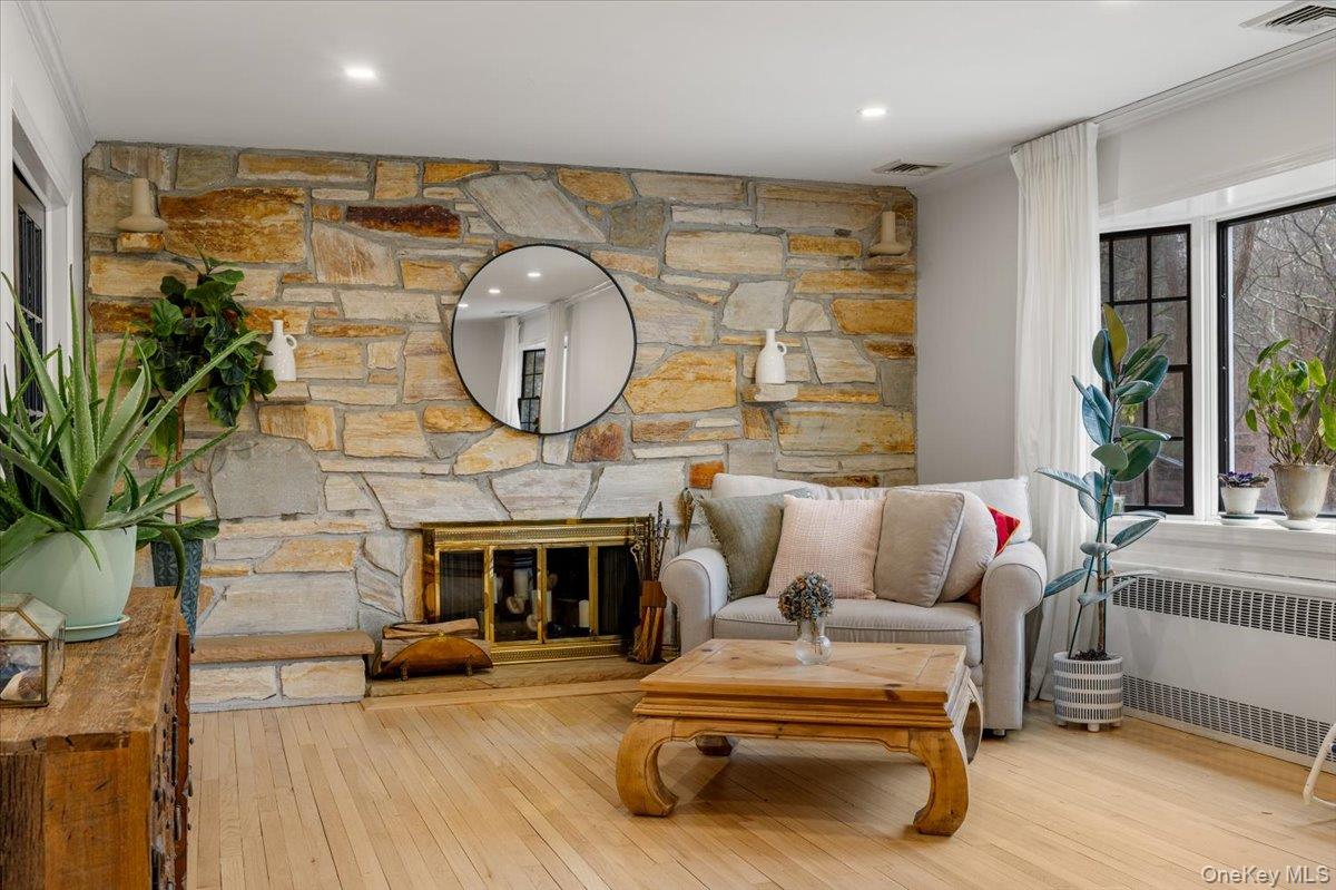 223 Bread And Cheese Hollow Road Northport, NY 11768 - Photo 11 of 32 a living room with furniture a fireplace and a potted plant