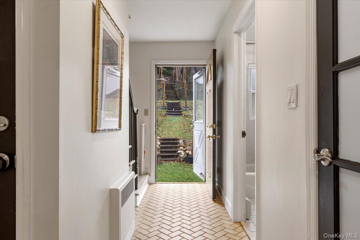 223 Bread And Cheese Hollow Road Northport, NY 11768 - Photo 15 of 32 a view of a hallway with wooden floor and a bathroom