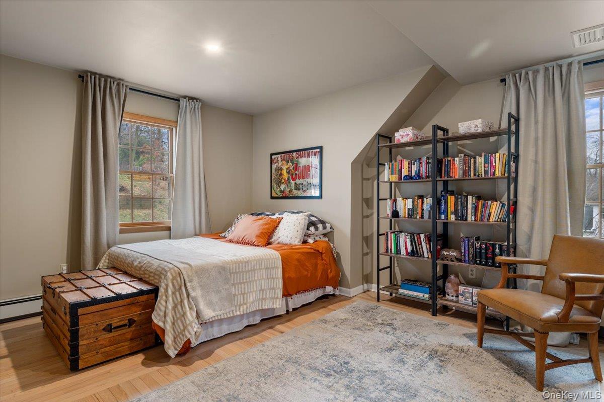 223 Bread And Cheese Hollow Road Northport, NY 11768 - Photo 20 of 32 a bedroom with a bed furniture and a book shelf