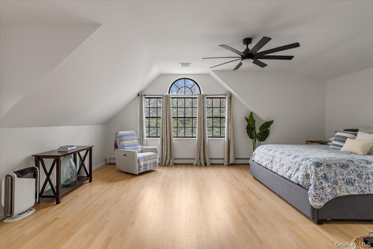 223 Bread And Cheese Hollow Road Northport, NY 11768 - Photo 23 of 32 a bedroom with a bed and a view of sliding door