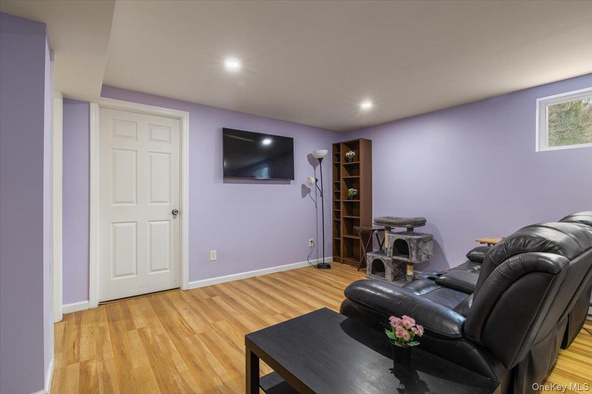 223 Bread And Cheese Hollow Road Northport, NY 11768 - Photo 25 of 32 a room with a couch and a flat screen tv