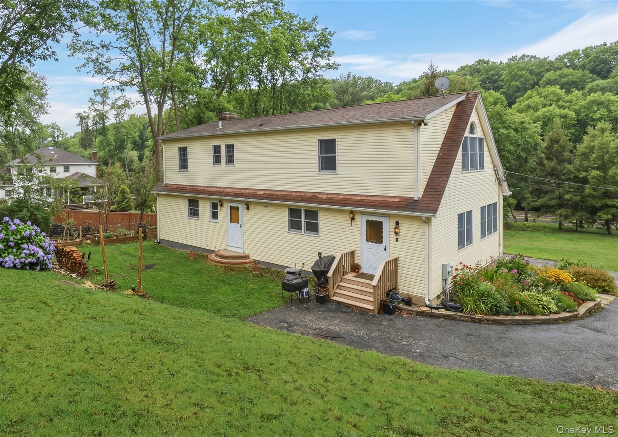 223 Bread And Cheese Hollow Road Northport, NY 11768 - Photo 27 of 32 a view of a house with backyard sitting area and garden